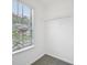 A walk-in closet with carpet, window, and wire shelving for organized storage at 1147 Saint Phillips Ct, Locust Grove, GA 30248