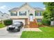 Charming two-story home with green shutters, a well-manicured lawn, and a two-car garage at 1147 Saint Phillips Ct, Locust Grove, GA 30248