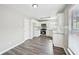 Bright kitchen boasts stainless steel appliances, white cabinetry, and hardwood floors at 1147 Saint Phillips Ct, Locust Grove, GA 30248