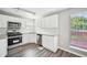 Bright kitchen boasts stainless steel appliances, granite countertops, and hardwood floors at 1147 Saint Phillips Ct, Locust Grove, GA 30248