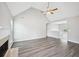 Spacious living room featuring vaulted ceilings, a fireplace, and modern laminate flooring at 1147 Saint Phillips Ct, Locust Grove, GA 30248