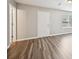 This living room features hardwood floors, a white door, and a window for natural light at 1147 Saint Phillips Ct, Locust Grove, GA 30248