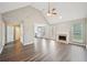 Spacious living room featuring vaulted ceilings, a fireplace, and modern laminate flooring at 1147 Saint Phillips Ct, Locust Grove, GA 30248