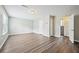Spacious living room with hardwood style floors boasts natural light and multiple entryways at 1147 Saint Phillips Ct, Locust Grove, GA 30248