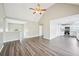 Open living room and kitchen floor plan featuring vaulted ceilings and modern laminate flooring at 1147 Saint Phillips Ct, Locust Grove, GA 30248