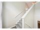 Carpeted staircase featuring white railings leading to the upper level of the home at 1147 Saint Phillips Ct, Locust Grove, GA 30248