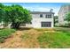 Two-story home showcasing a well-maintained backyard, a concrete patio, and black framed french doors at 3684 Clearbrooke Way, Duluth, GA 30097