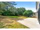 Expansive backyard showing a grass lawn, concrete patio, and lush trees that provide privacy at 3684 Clearbrooke Way, Duluth, GA 30097