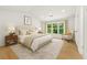 Serene bedroom with neutral tones, ample natural light, and a comfortable seating area at 3684 Clearbrooke Way, Duluth, GA 30097