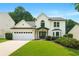 Charming two-story home with manicured lawn, black trim, arched window, and a two-car garage at 3684 Clearbrooke Way, Duluth, GA 30097