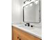 Stylish powder room featuring wood cabinets, white marble countertops, and a rectangular mirror at 3684 Clearbrooke Way, Duluth, GA 30097