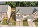 Aerial view of the townhome showcases its well-kept lawn, brick and siding exterior, and driveway at 4161 Magnolia Glen Walk, Norcross, GA 30093
