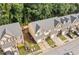 Aerial view displaying the neighborhood townhomes, landscaping, and community street at 4161 Magnolia Glen Walk, Norcross, GA 30093