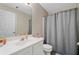 Bathroom featuring a single sink vanity, toilet, and shower with gray shower curtain at 4161 Magnolia Glen Walk, Norcross, GA 30093