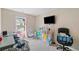 Comfortable bedroom featuring a window, television, and functional storage space at 4161 Magnolia Glen Walk, Norcross, GA 30093