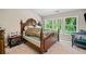 Bedroom featuring a wooden bed frame, large windows, and bright natural light at 4161 Magnolia Glen Walk, Norcross, GA 30093