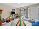 Bedroom featuring toys, a TV, and a window bringing in natural light, creating a playful space at 4161 Magnolia Glen Walk, Norcross, GA 30093