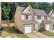 Inviting townhome boasts a brick facade, well-maintained landscaping, and an attached single-car garage at 4161 Magnolia Glen Walk, Norcross, GA 30093