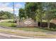 Attractive community sign with decorative brickwork and landscaping with seasonal color at 4161 Magnolia Glen Walk, Norcross, GA 30093