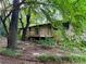 Home boasts lush green surroundings, mature trees, and a spacious deck at 4323 Darwen Ct, Tucker, GA 30084