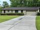 Charming single-story home with a well-manicured front yard and extended concrete driveway at 4323 Darwen Ct, Tucker, GA 30084