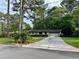 Inviting single-story home with lush lawn, driveway and a beautiful landscape, surrounded by mature trees at 4323 Darwen Ct, Tucker, GA 30084