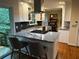 Modern kitchen with granite countertops, stainless steel appliances, and stylish bar stools at 4323 Darwen Ct, Tucker, GA 30084