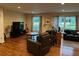 Spacious living room with hardwood floors, cozy seating, and abundant natural light from large windows at 4323 Darwen Ct, Tucker, GA 30084
