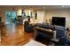 Open-concept living area featuring hardwood floors, leather furniture, and a kitchen with modern appliances at 4323 Darwen Ct, Tucker, GA 30084