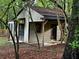 Charming outbuilding featuring a covered porch and modern doors at 4323 Darwen Ct, Tucker, GA 30084