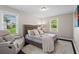Bright bedroom with hardwood floors, natural light and a comfortable lounge chair at 629 Dunton Se Cir, Smyrna, GA 30082