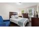 Cozy bedroom featuring hardwood floors, two windows, and neutral décor at 629 Dunton Se Cir, Smyrna, GA 30082