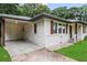 Home with a covered parking area, white siding, and charming wood shutters at 629 Dunton Se Cir, Smyrna, GA 30082