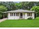 Charming single-story home featuring white paint, wood shutters, and a well-maintained lawn at 629 Dunton Se Cir, Smyrna, GA 30082
