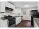 Modern kitchen features granite counters, stainless steel appliances, and sleek white cabinetry at 629 Dunton Se Cir, Smyrna, GA 30082