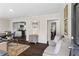 Inviting living room featuring stylish furnishings, neutral paint, and hardwood floors flowing to a modern kitchen at 629 Dunton Se Cir, Smyrna, GA 30082