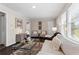 Inviting living room featuring stylish furnishings, neutral paint, and hardwood floors flowing to a modern kitchen at 629 Dunton Se Cir, Smyrna, GA 30082