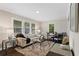 Inviting living room featuring stylish furnishings, neutral paint, and hardwood floors flowing to a modern kitchen at 629 Dunton Se Cir, Smyrna, GA 30082
