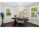 Bright office space featuring hardwood floors, a large desk, and two windows at 629 Dunton Se Cir, Smyrna, GA 30082