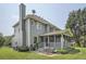 Backyard of home with patio, screen porch, grass, plants and patio furniture at 750 Gates Ln, Alpharetta, GA 30022