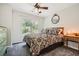 This bedroom provides great natural light with a ceiling fan, plush carpet, and neutral paint at 750 Gates Ln, Alpharetta, GA 30022
