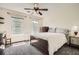 This bedroom is filled with natural light, neutral paint, plush carpet, and a ceiling fan at 750 Gates Ln, Alpharetta, GA 30022