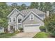 Charming two-story home featuring a well-maintained lawn, attached two car garage, and mature trees at 750 Gates Ln, Alpharetta, GA 30022