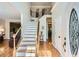 Bright foyer featuring hardwood floors, staircase with wood and wrought iron, and neutral walls at 750 Gates Ln, Alpharetta, GA 30022