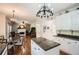 Spacious kitchen with granite countertops, hardwood floors, and a view into an open Gathering room at 750 Gates Ln, Alpharetta, GA 30022