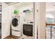Bright laundry room features modern washer and dryer units with storage space and natural lighting at 750 Gates Ln, Alpharetta, GA 30022