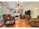 Bright living room with hardwood floors, fireplace, and comfortable seating with a neutral color palette at 750 Gates Ln, Alpharetta, GA 30022