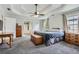 Spacious main bedroom featuring tray ceilings, a ceiling fan, neutral walls, and plush carpeting at 750 Gates Ln, Alpharetta, GA 30022