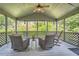 Enclosed porch with wicker chairs and outdoor view at 750 Gates Ln, Alpharetta, GA 30022