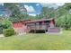 Backyard with a hot tub on the deck and a lush green yard at 1148 Woodland Cir, Lawrenceville, GA 30043